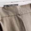 Pantaloni cu croi larg și pliuri
