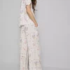 Pantaloni de pijama cu croi larg și imprimeu floral Pantaloni de pijama cu croi larg și imprimeu floral